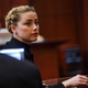 Amber Heard looks over he shoulder during the 50 million US dollars Depp vs Heard defamation trial at the Fairfax County Circuit Court in Fairfax, Virginia,on April 14, 2022. - Heard is being sued for defamation by her former husband, US actor Johnny Depp, after she wrote an op-ed in The Washington Post in 2018 that, without naming Depp, accused him of domestic abuse.